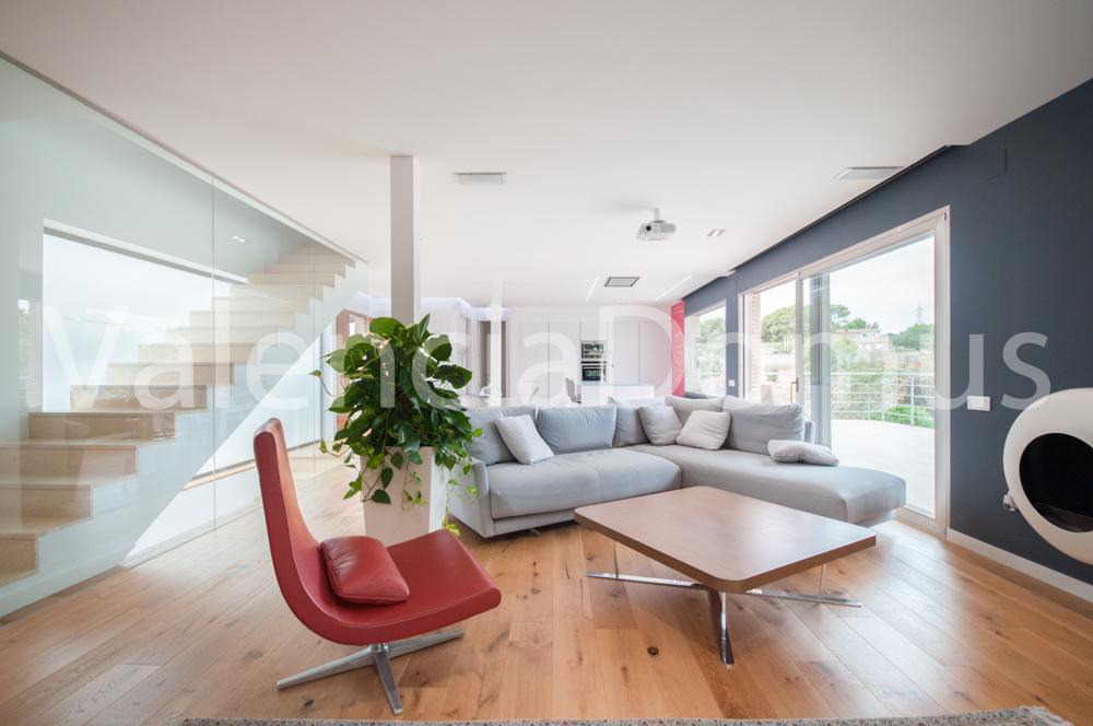 Living room and stairs to upper floor with Antrax chimney